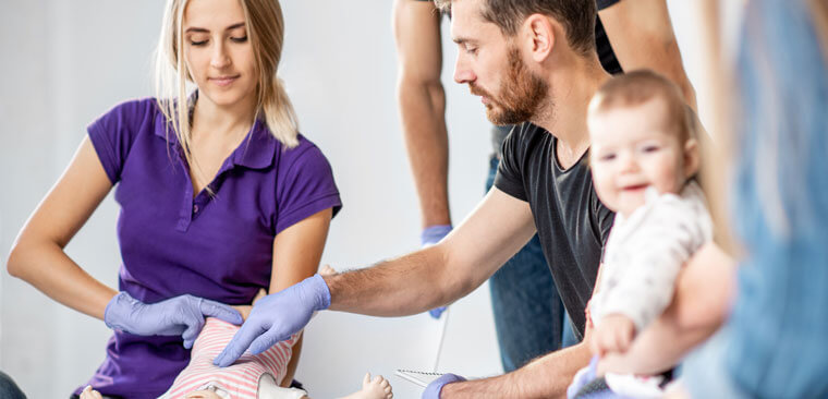 Healthcare workers training on a dummy